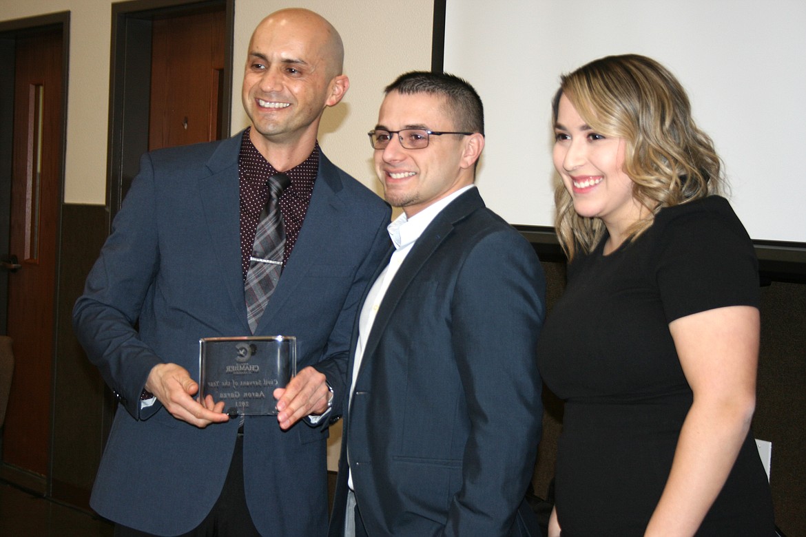 Othello Police Department Sergeant Aaron Garza (left) was recognized as the Civil Servant of the Year during the Othello Chamber of Commerce banquet Friday. Current Othello Chamber president Mat Garza (center) and 2023 president Thalia Lemus (right) presented the award.