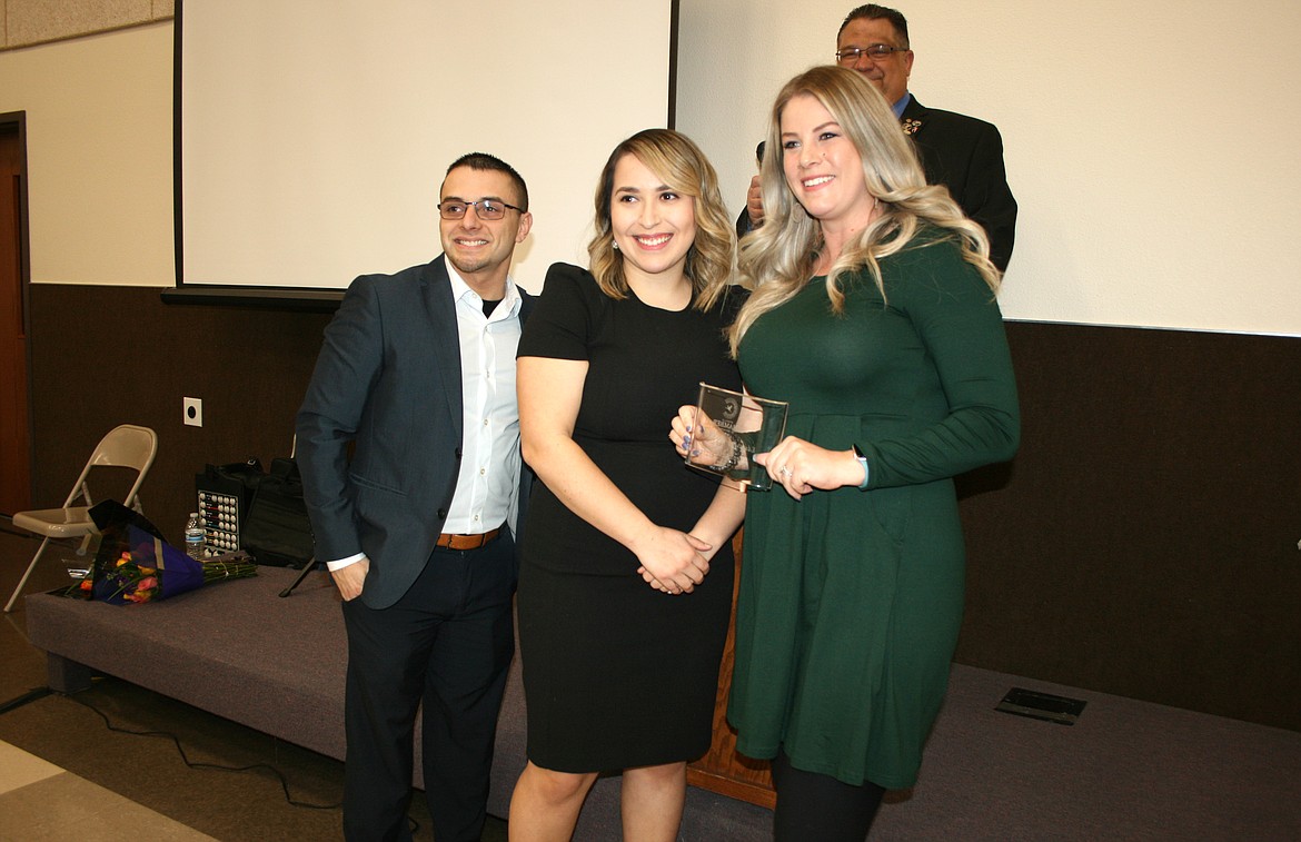 Wahitis Elementary teacher Stephanie Garza (right) received the K-5 Teacher of the Year award from 2022 Othello Chamber of Commerce banquet president Mat Garza (left) and 2023 president Thalia Lemus (center) during the Chamber’s annual banquet Friday.