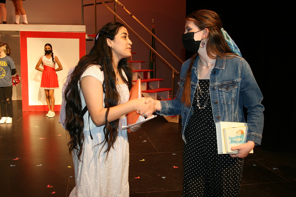 0304 Quincy HS play feature 2:
Cheryl Schweizer/Columbia Basin Herald
Gabriella (Xitlaly Trejo, left) makes a new friend in Taylor (Brooke Melburn, right)  on her first day at East High in the Quincy High School production of “High School Musical.” Photos for this story were taken during a rehearsal for the play.