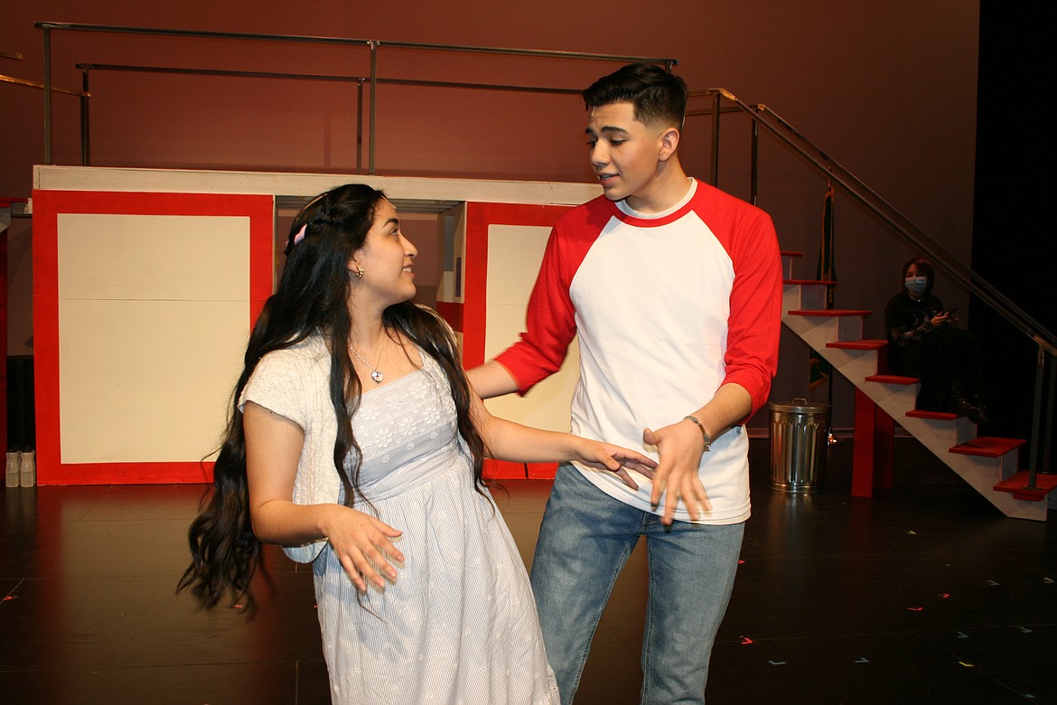 Gabriella (Xitlaly Trejo, left) and Troy (Manny Diaz, right) get to know each other better in Quincy High School’s production of “High School Musical.” The play features two high school students from different cliques connecting.