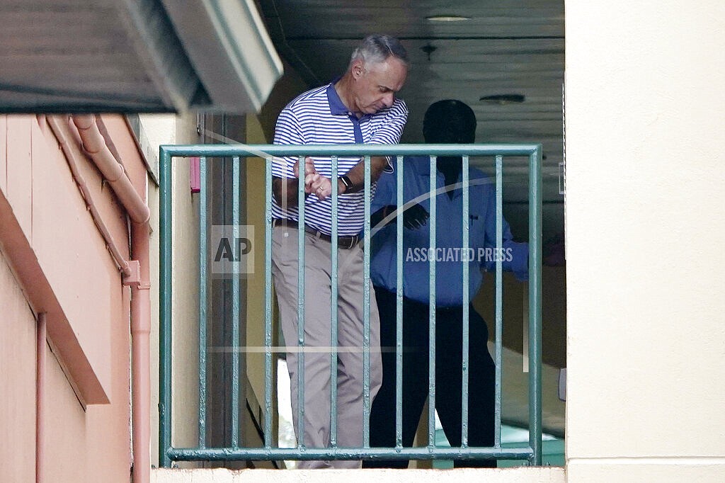 Major League Baseball Commissioner Rob Manfred practices his golf swing as negotiations continue with the players' association toward a labor deal, Tuesday, March 1, 2022, at Roger Dean Stadium in Jupiter, Fla. (AP Photo/Lynne Sladky)