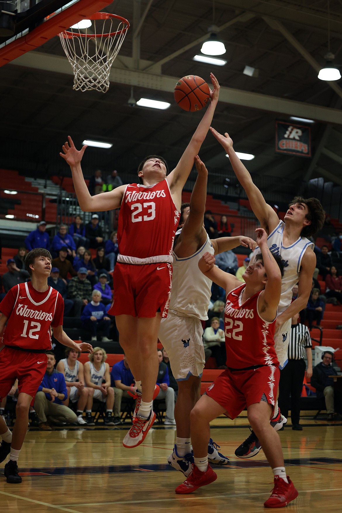 Arlee's Benjamin Old Person-Harlow pulls down a rebound against Bigfork during the Warriors' opener at the Western B divisional tournament in Ronan. (Jeremy Weber/Daily Inter Lake)