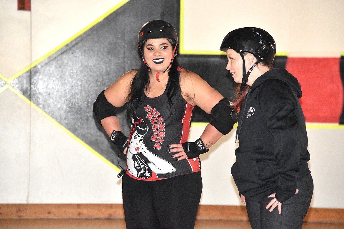 Nani Bosnar, left, talks with Kristina Allman at practice on Feb. 1 about what skill to work on next.