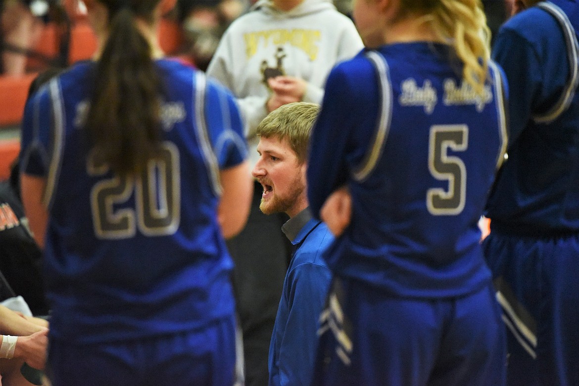 Mission head coach Dalton Delaney talks with his players during a timeout against Powell County on Friday. (Scot Heisel/Lake County Leader)