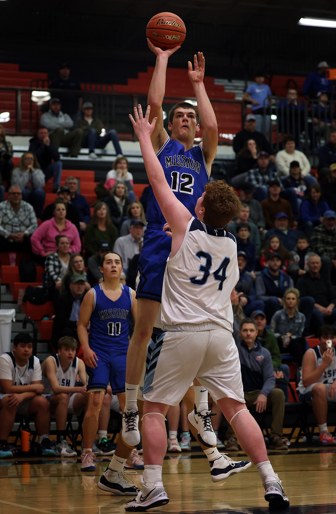 Mission's Ross McPherson rises above Loyola defender Noah Haffey for a shot at Ronan. (Jeremy Weber/Daily Inter Lake)