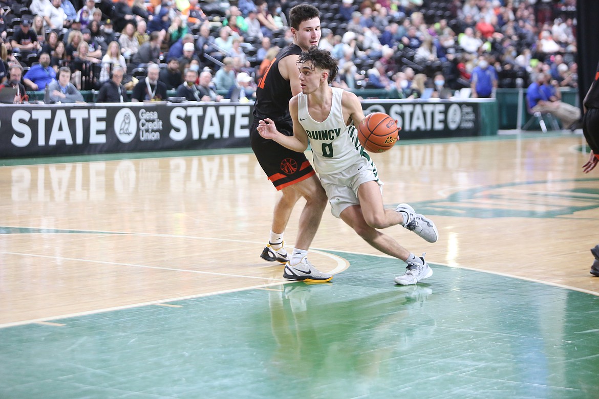 Jalen Spence drives to the basket during Quincy’s first game in the 1A Hardwood Classic state basketball tournament Wednesday.