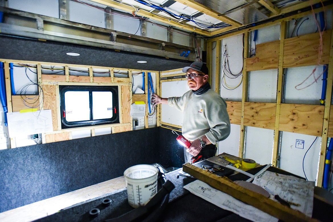 Mike Bare shows the unfinished interior of one of the custom coach mobile command vehicles at Nomad Global Communication Solutions on Wednesday, March 2. (Casey Kreider/Daily Inter Lake)