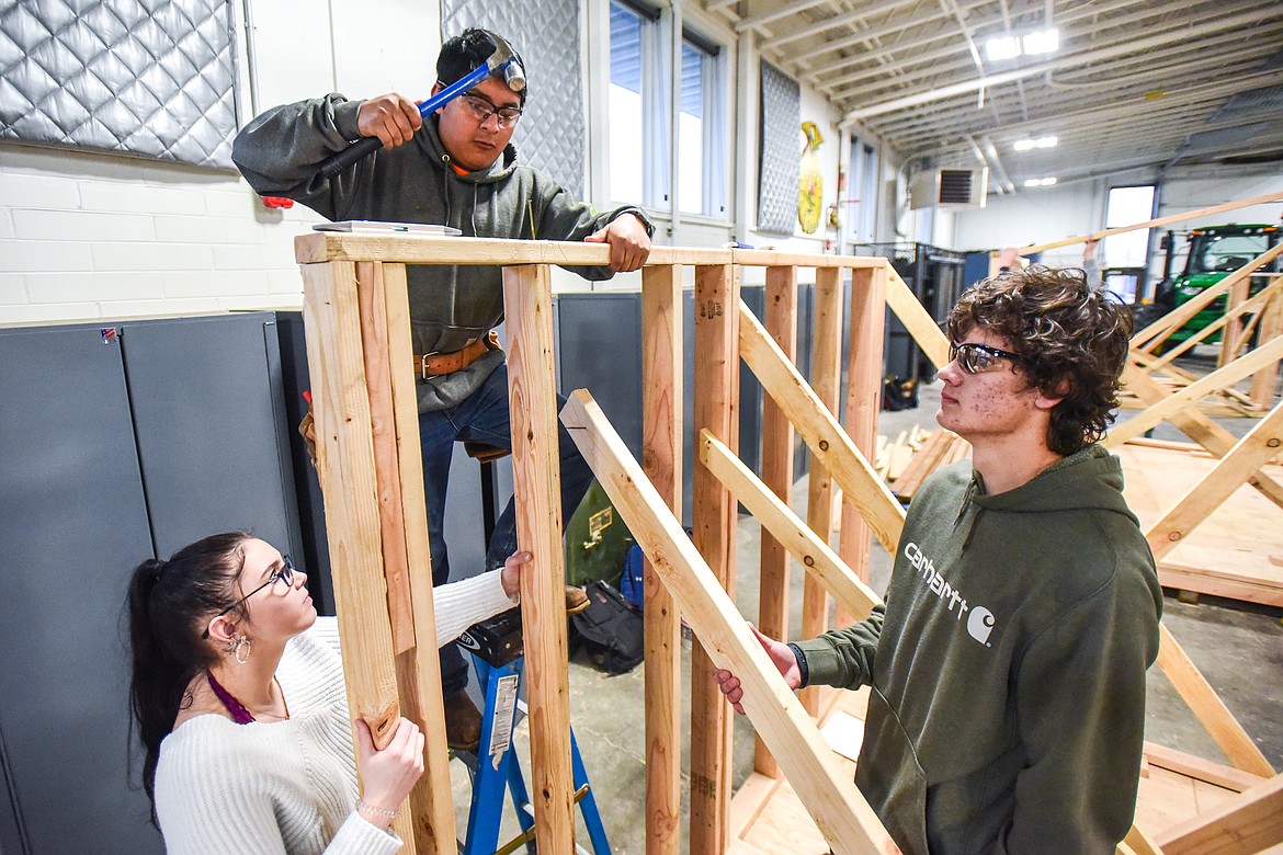 Glacier High School juniors, from left, Kylie Mercer, Gustavo Chace and Boe Tutvedt work on the outer frame of a shed at the H.E. Robinson Agricultural Education Center in Kalispell on Wednesday, March 2. (Casey Kreider/Daily Inter Lake)