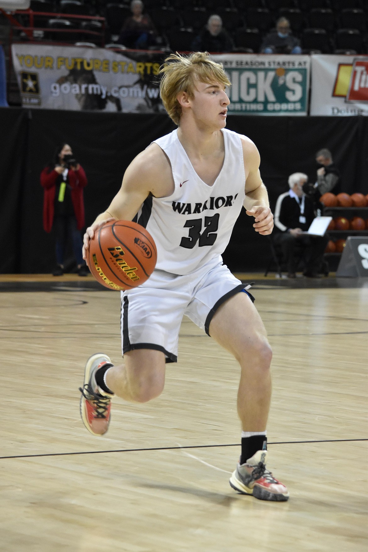 ACH senior Cooper Correia (32) brings the ball down court during the state matchup against Lummi Nation on March 3 at the Spokane Arena.