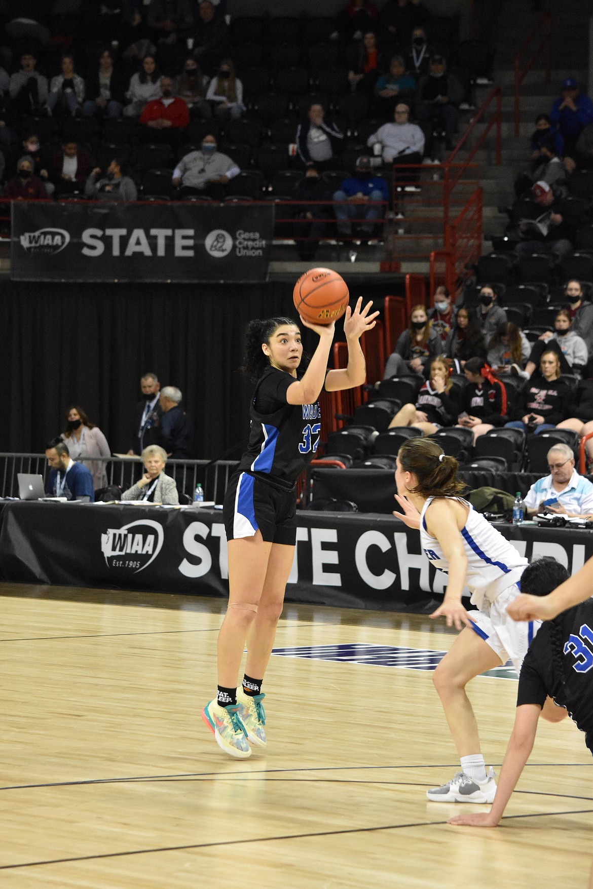 Warden High School senior Kiana Rios (32) shoots for a three-pointer at the WIAA 2B girls state tournament against La Conner.