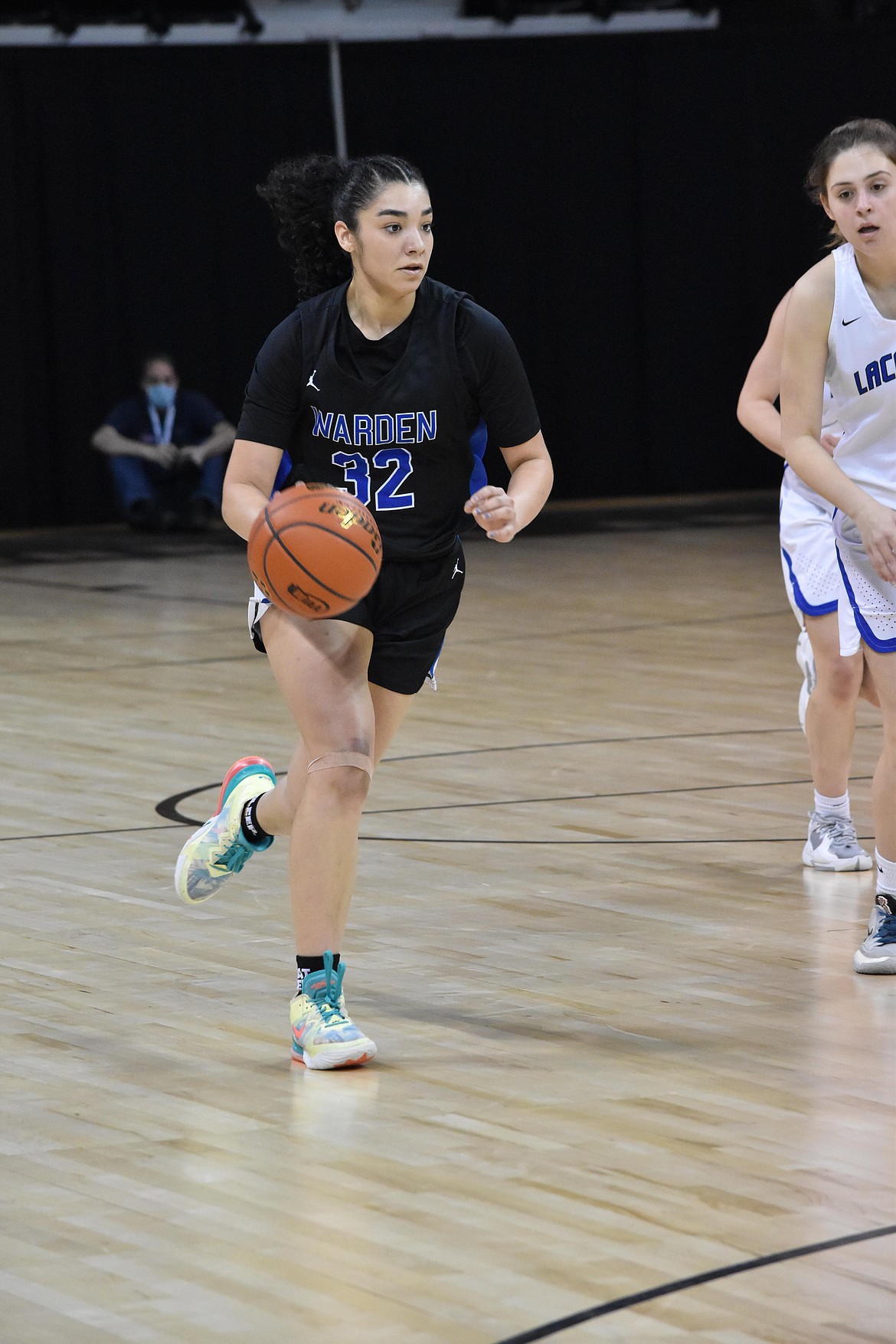 Warden High School senior Kiana Rios (32) drives the ball downcourt in her team’s game against La Conner on March 3 at the Spokane Arena. Warden took the game 61-48.