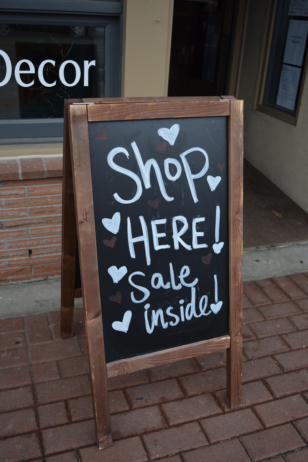 A sale sign out in front of Jenna Hildebrand’s boutique, Love & Lumber, at its new location in downtown Moses Lake. Hildebrand expanded the shop in November after seeing success at another location.