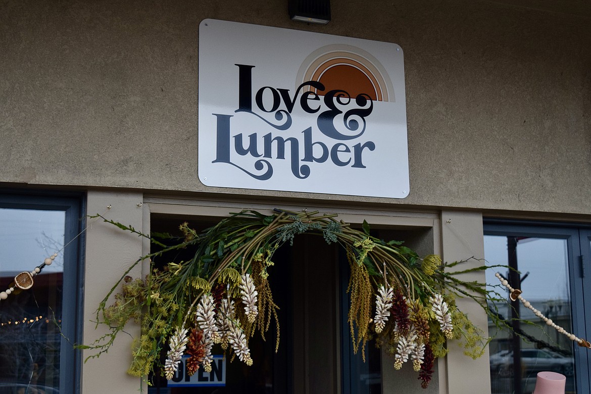 The signage above the entrance to Love & Lumber matches much of the color palette inside the shop which features handmade jewelry, home decor and an owner who says she wants everyone to feel welcome.