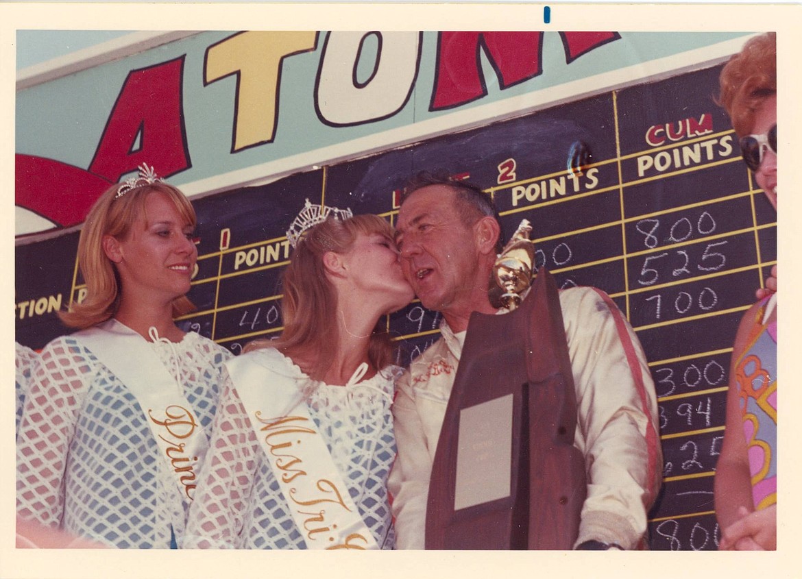 Col. Gardner receives a congratulatory kiss from Miss Tri-Cities 1968, Cynthia Klinger after winning the Atomic Cup trophy with the Miss Eagle Electric. Looking on are (left) an unidentified Tri-Cities princess and Elaine Heerensperger, wife of David Heerensperger, owner of the Miss Eagle Electric.