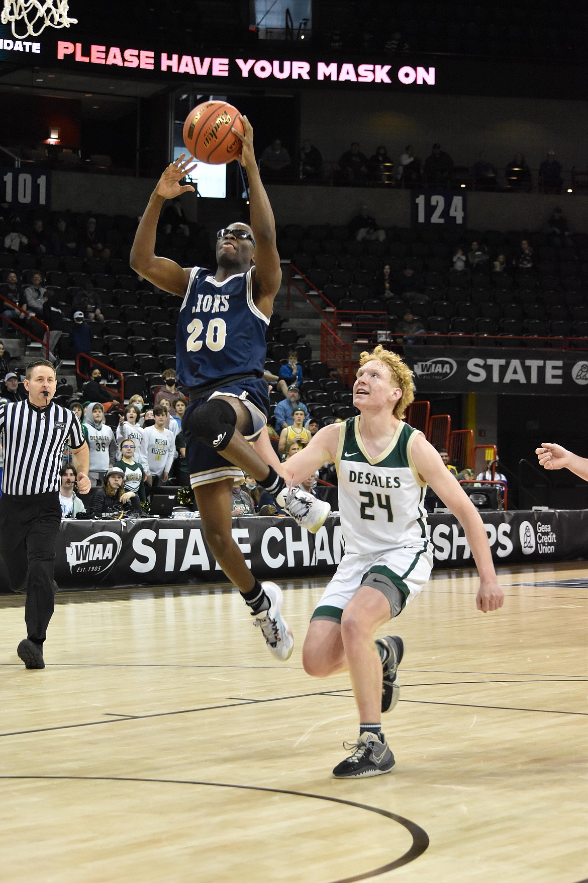 MLCA/CCS junior Jeff Boorman (20) goes in for a layup on March 4, during the matchup  against the DeSales Irish at the state basketball tournament.