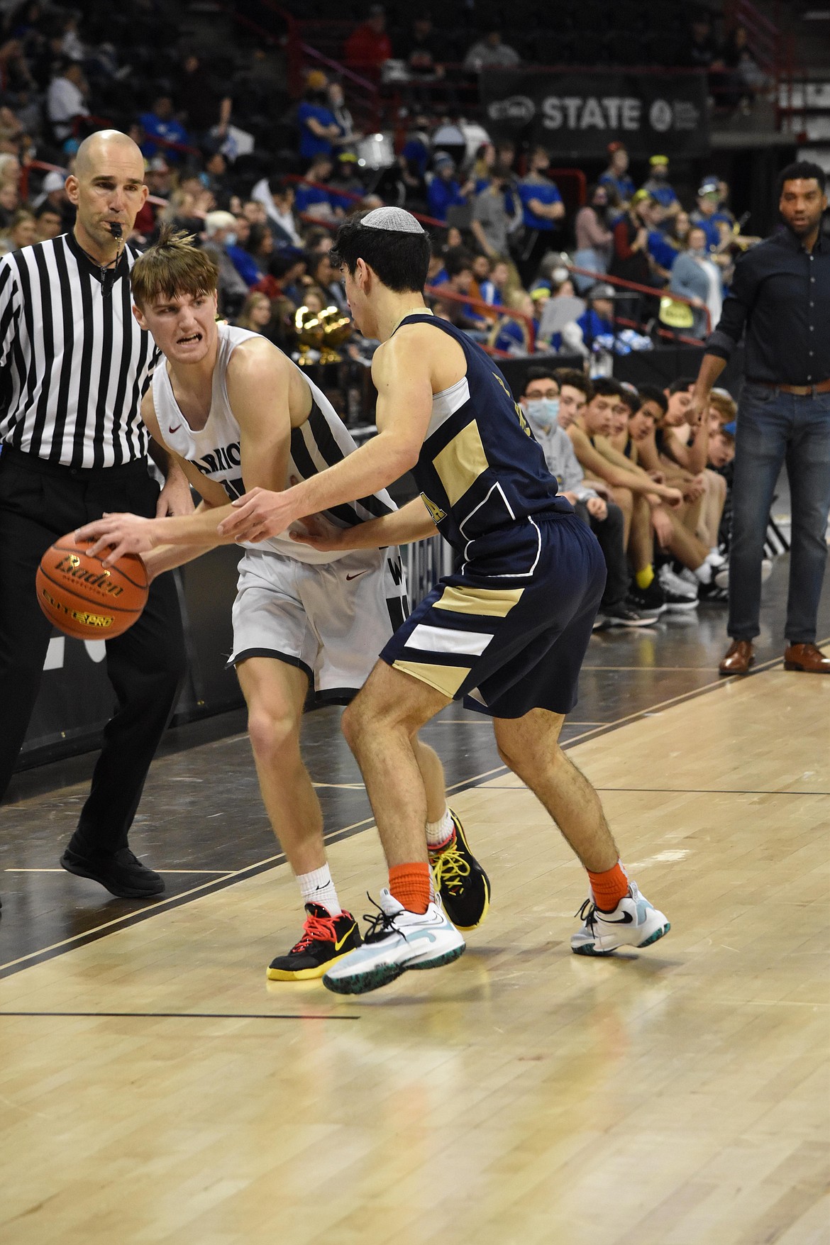 ACH senior (25) Grady Murray tries to pass the ball to a teammate as an opponent guads him on March 4, during the matchup against Northwest Yeshiva at the state basketball tournament in spokane.