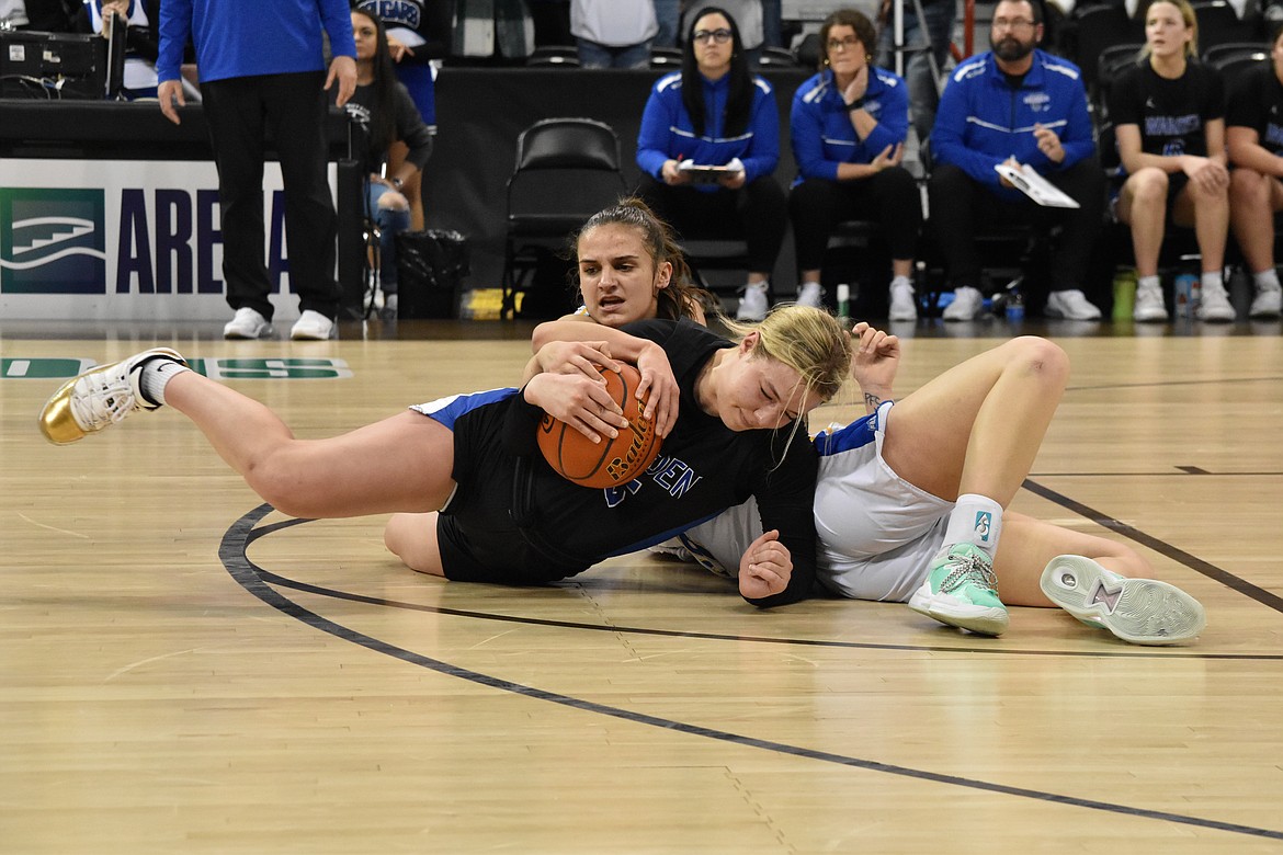 Warden High School senior Jaryn Madsen (5) wrestles for the ball on March 5 during the state championship game against Colfax.