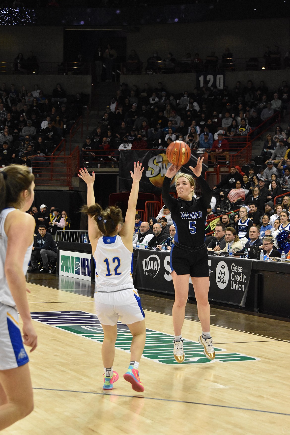 Warden High School senior Jaryn Madsen (5) attempts a three-point shot during the state championship game of the WIAA state 2B girls tournament on March 5.