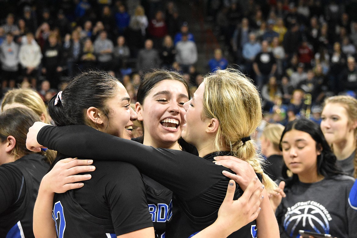 From left to right, seniors Kiana Rios, Rylee McKay and Jaryn Madsen celebrate their win and state title on March 5. Madsen was the top scorer in the championship game.