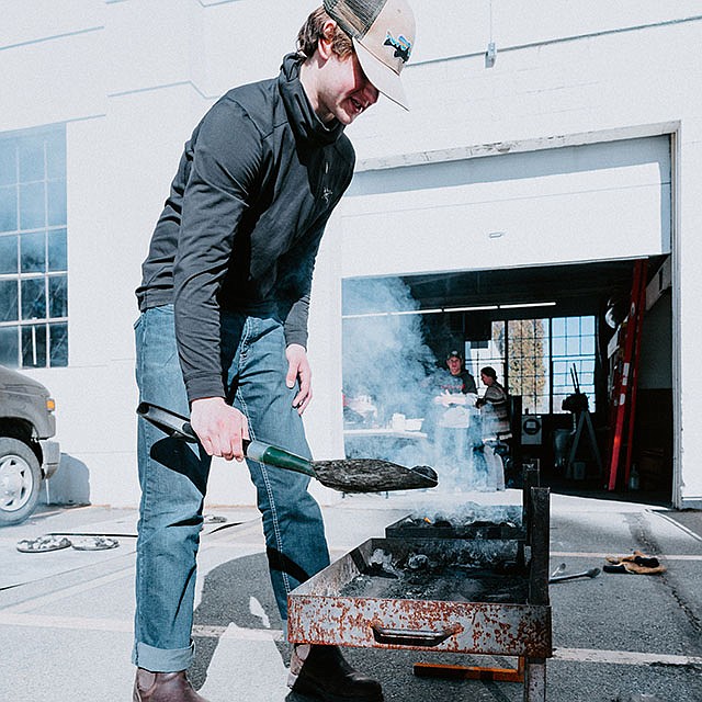 Photo by Elli Oba, North Idaho College
NIC student Luke Vogel prepares coals for Dutch ovens during an Introduction to Outdoor Cooking class on Feb. 23 at NIC’s McClain Hall.