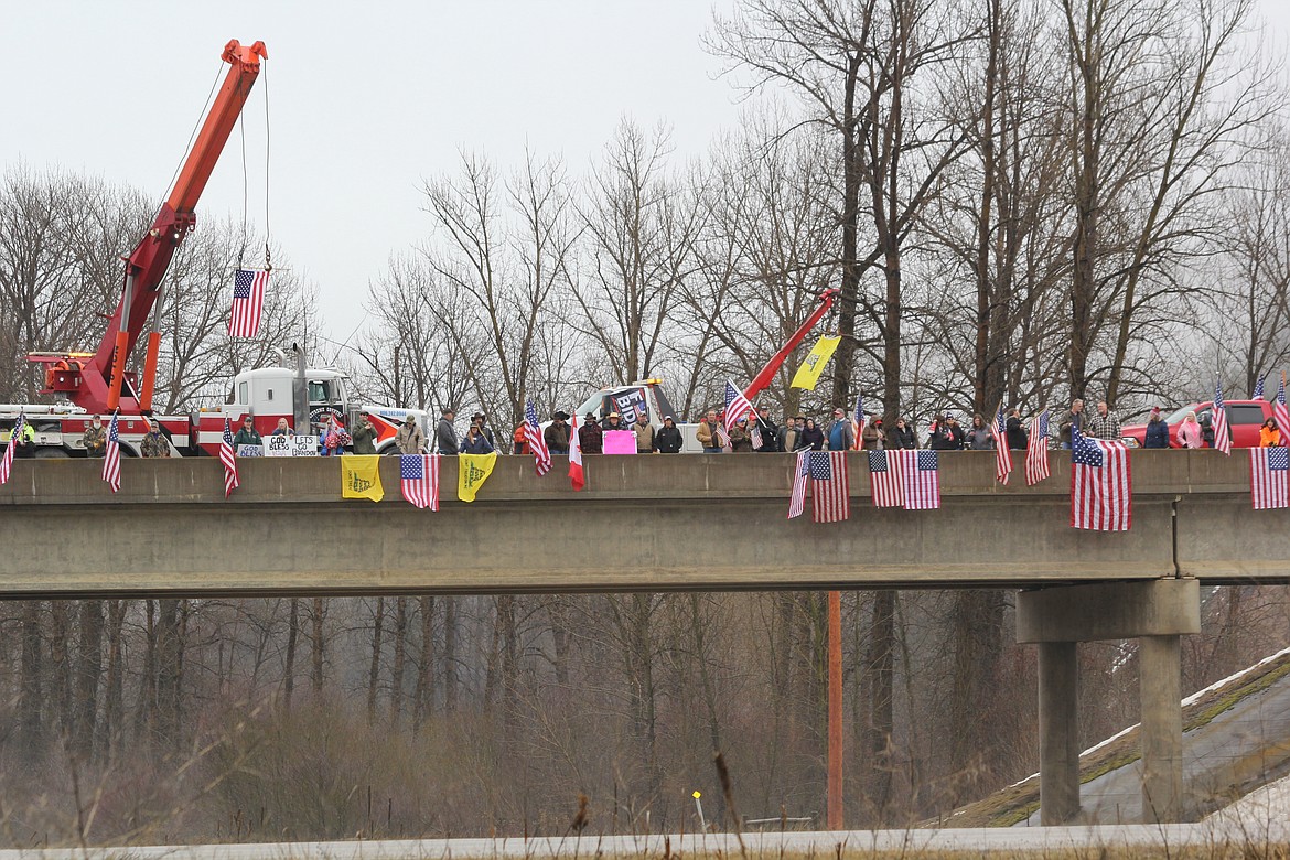 People gather on Little Joe overpass on I-90 on March 2 to support the American Truckers Freedom Convoy. (Monte Turner/Mineral Independent)