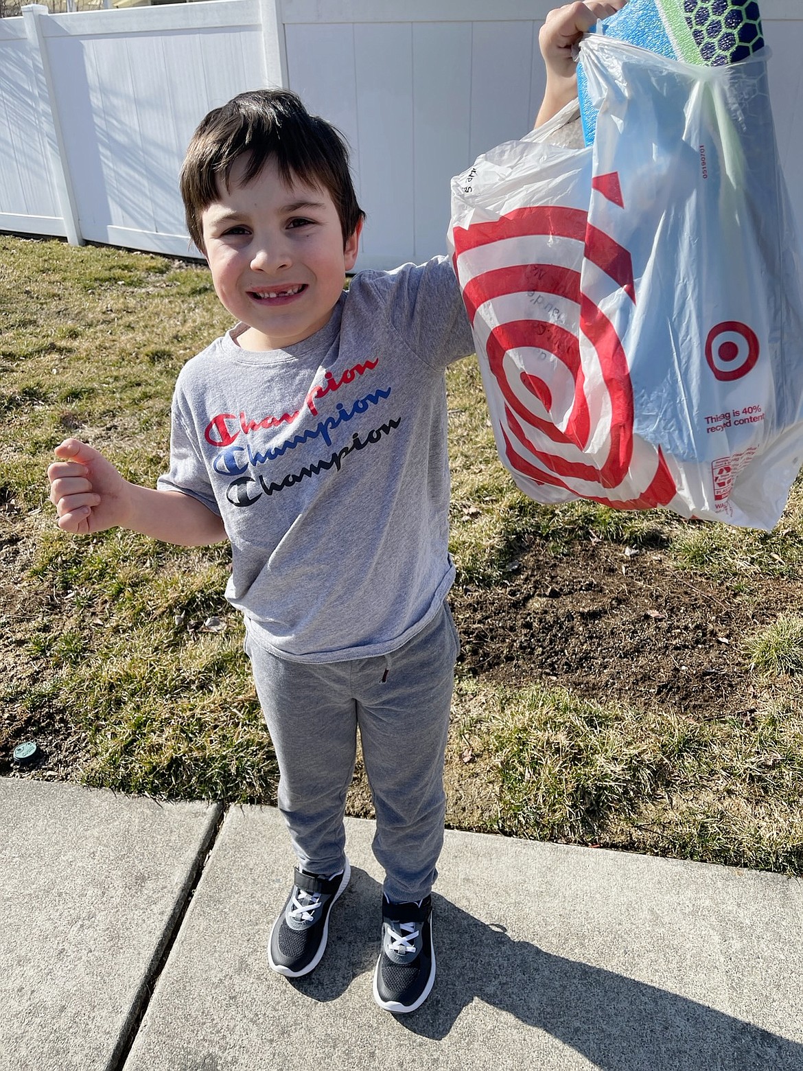 Jack Hagenbarth, 6, Post Falls, holds a bag of trash he collected from a neighborhood park near his house Sunday. His bike was stolen while he picked up the garbage, but the community has rallied to replace it.