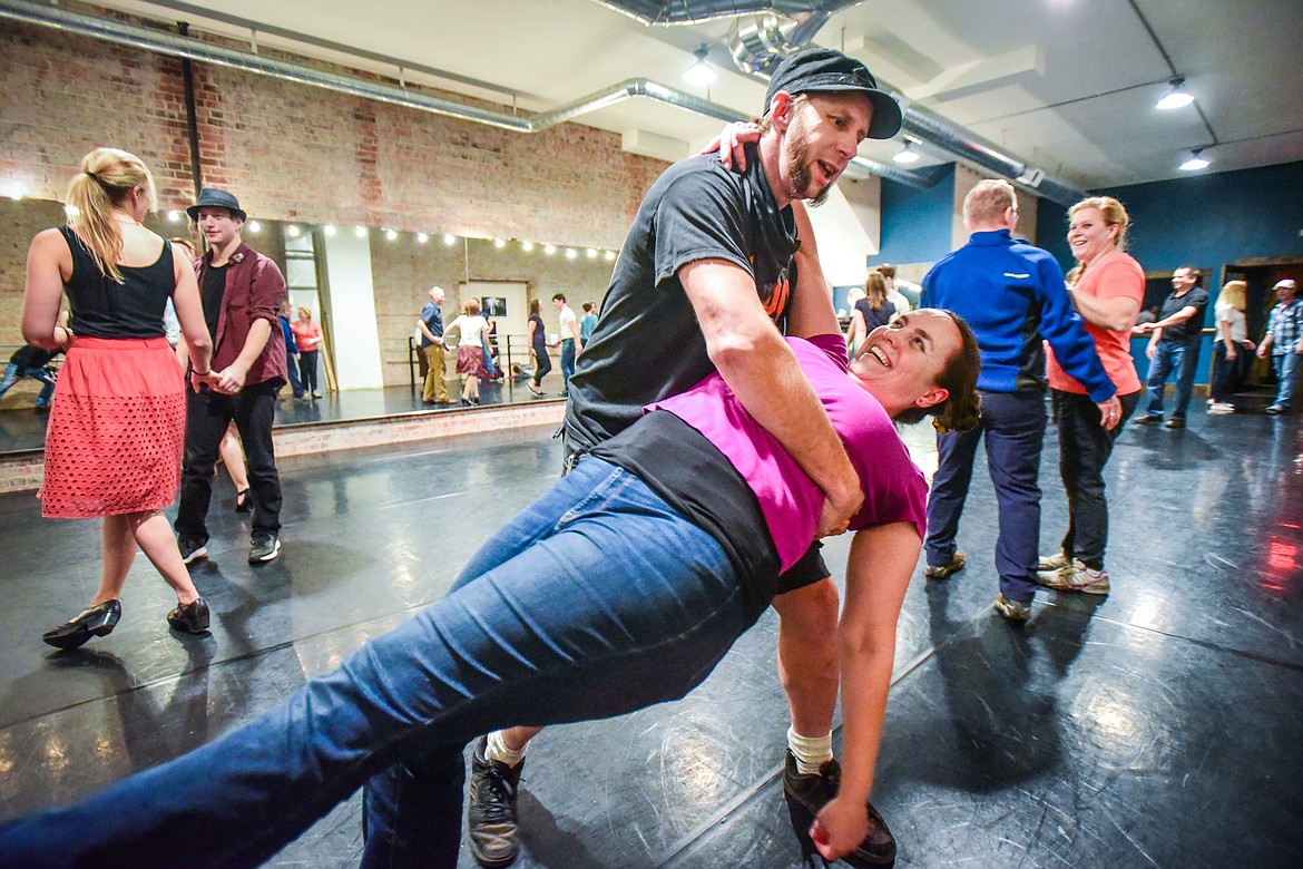 Justin Krauss dips "AK" during a social dance and beginner lesson held by North End Swing at Noble Dance in Kalispell on Friday, March 4. (Casey Kreider/Daily Inter Lake)