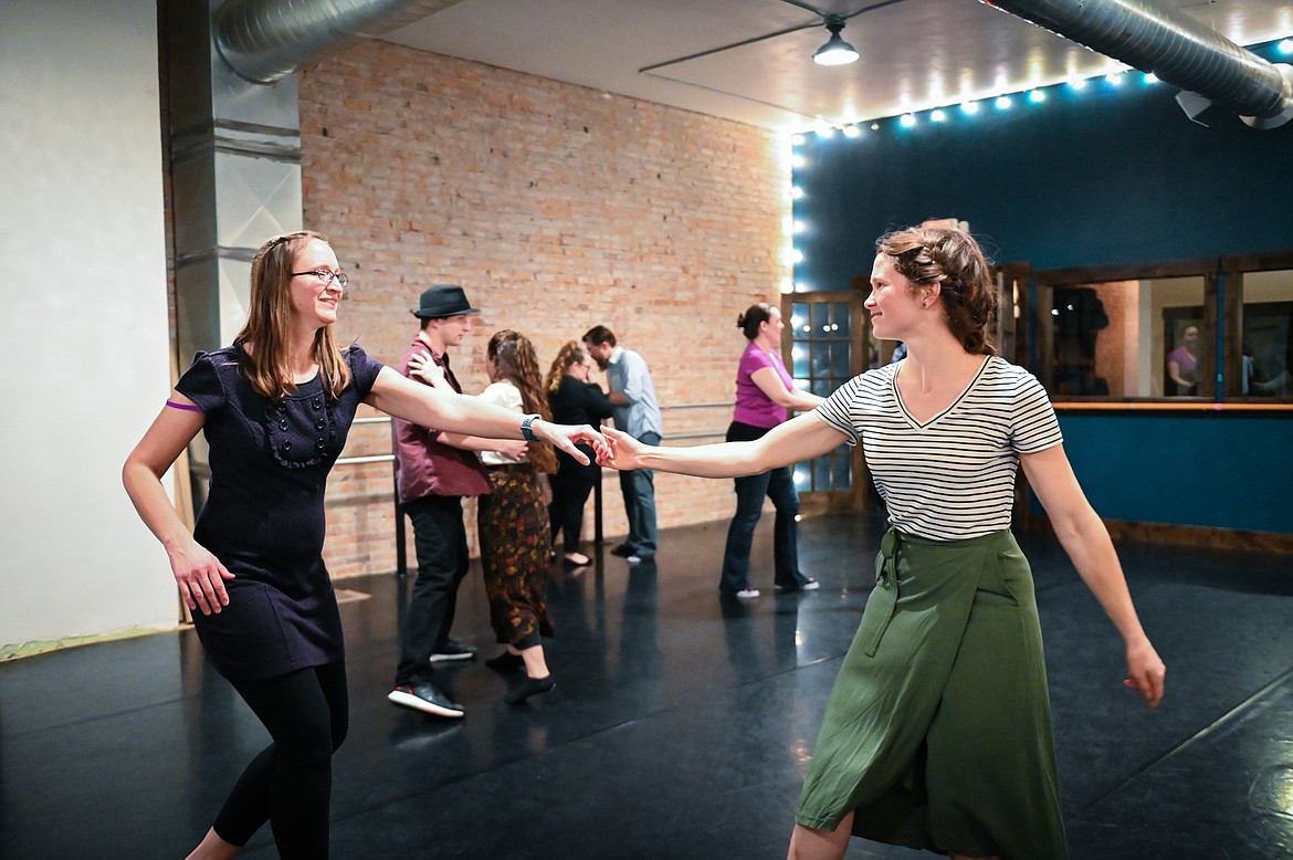 Instructors Emilie Erler and Hana Head dance  during a social dance and beginner lesson held by North End Swing at Noble Dance in Kalispell on Friday, March 4. (Casey Kreider/Daily Inter Lake)