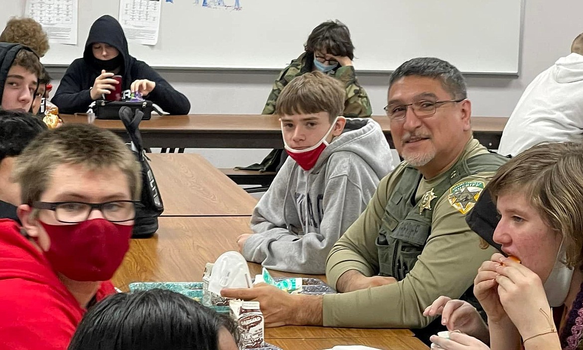 Adolfo Coronado sits with students at Lind Middle School on Feb. 28. Coronado, who also serves as undersheriff with the Adams County Sheriff’s Office, was recently named girls basketball coach of the year for his work with the Othello Lady Huskies.