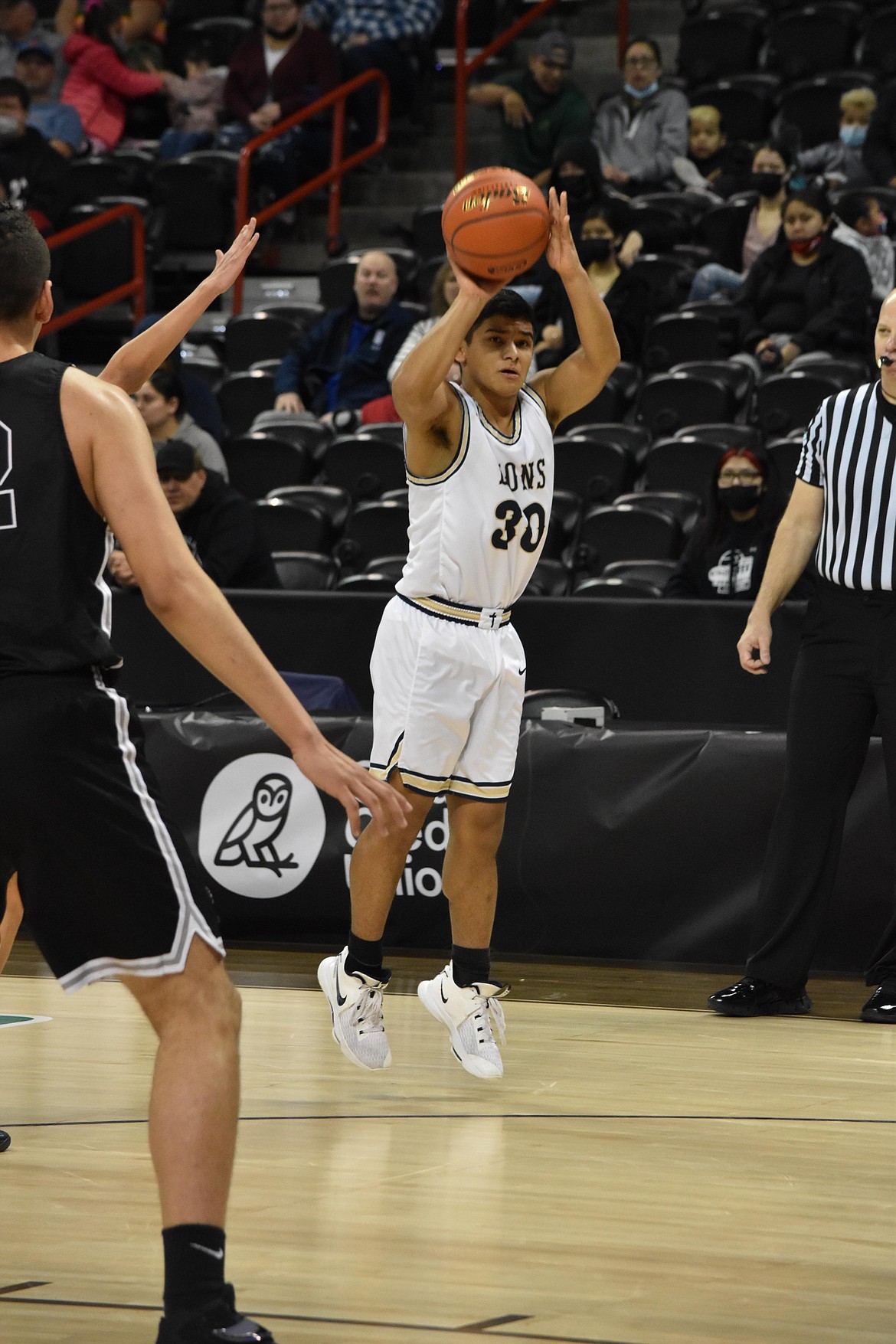 MLCA/CCS senior David Chavez (30) shoots a three-pointer during the matchup against Lummi Nation on March 5.