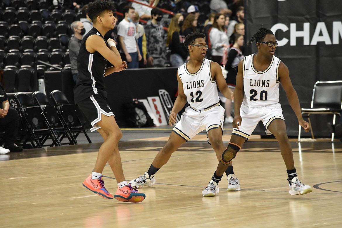 MLCA/CCS brothers Kenzy Boorman (12) and Jeff Boorman (20) guard their Lummi Nation opponents during the state tournament matchup on March 5.