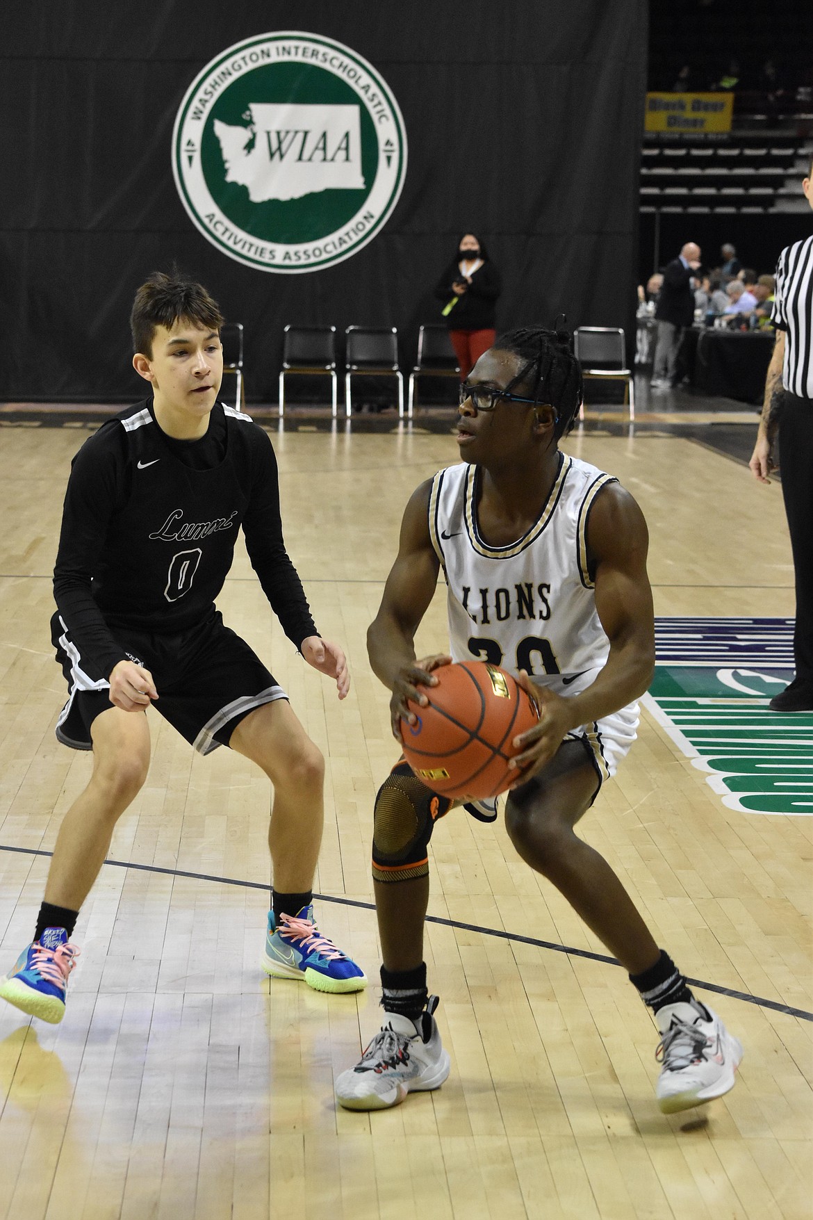 MLCA/CCS senior Jeff Boorman (20) looks to the basket as a Lummi Nation opponent guards nearby.