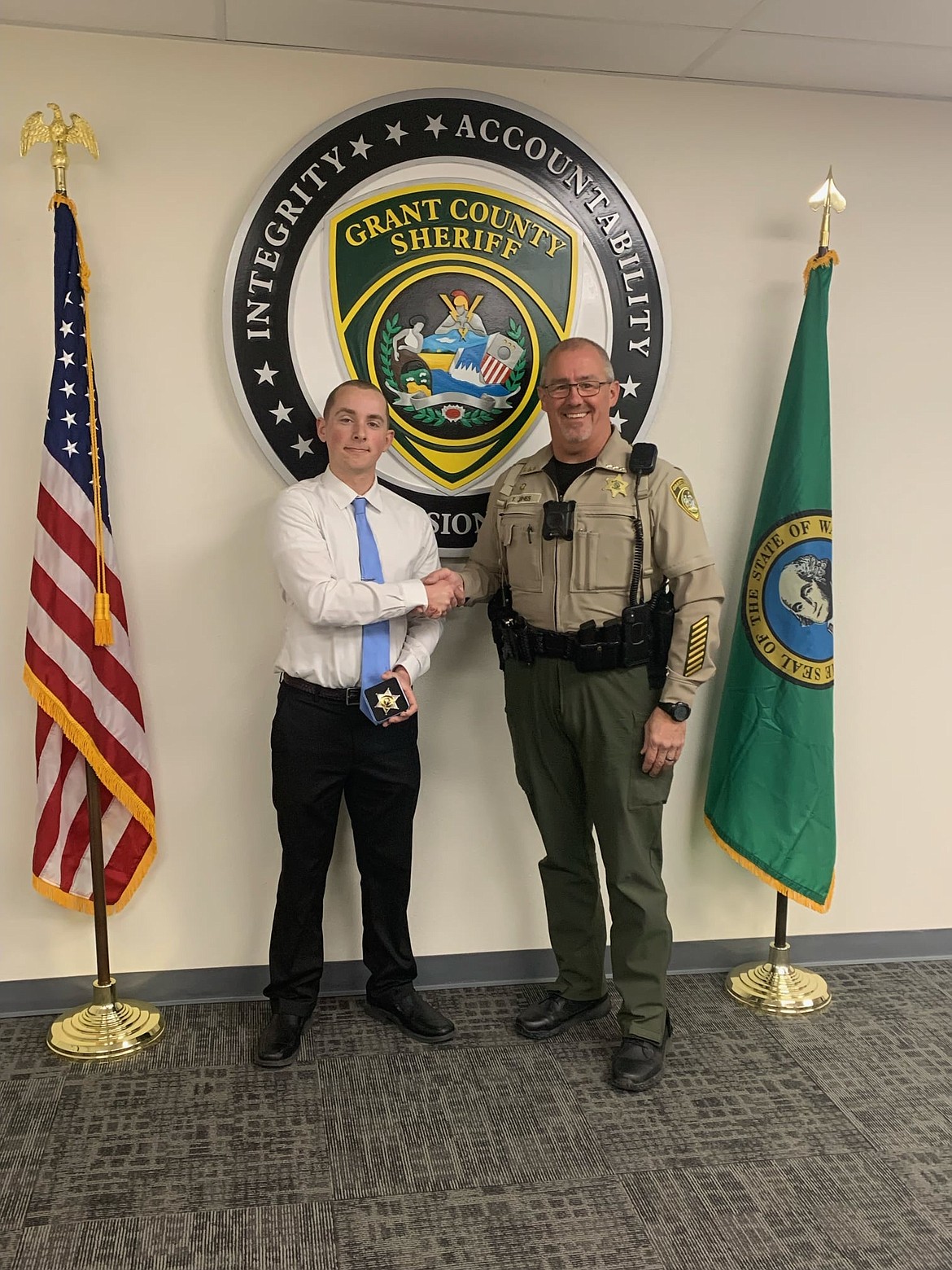 Grant County Sheriff Tom Jones (right) congratulates Corrections Deputy Colin Clemons (left) after swearing the new officer in on Feb. 22 of this year. The Grant County Sheriff’s Office oversees operations at the county jail and several other public safety programs.