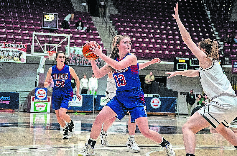 Columbia Falls senior Grace Gedlaman looks for an open teammate on Wednesday in Missoula at the State A basketball tournament. (JP Edge/Hungry Horse News)