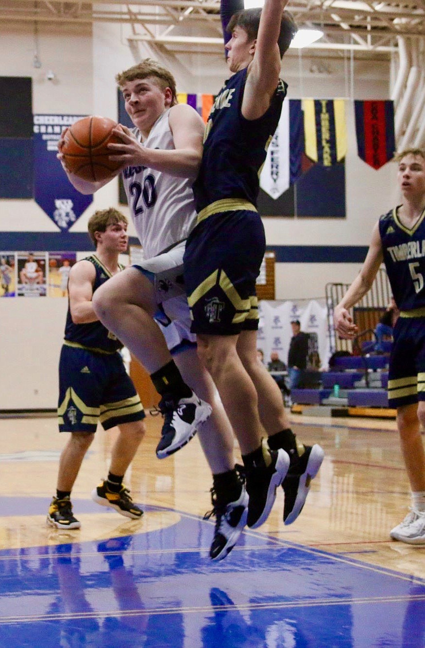 Trey Bateman going up for a lay-in against Timberlake during districts. At the 3A state competition, Bateman improved his three-point game draining threes.