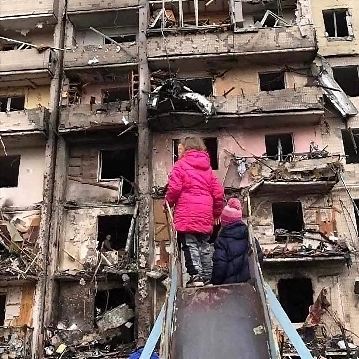 Children play outside a bombed apartment building in Kyiv, Ukraine. (photo provided by Oksana Nechenechy)