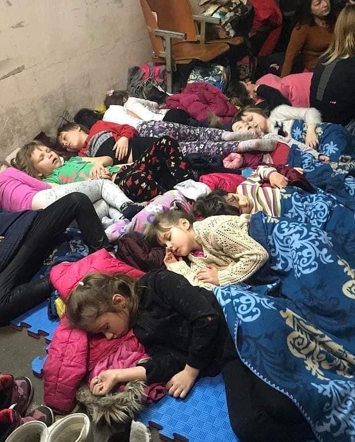 Children sleep in close quarters seeking safety inside a basement in Ukraine. (photo provided by Oksana Nechenechy)