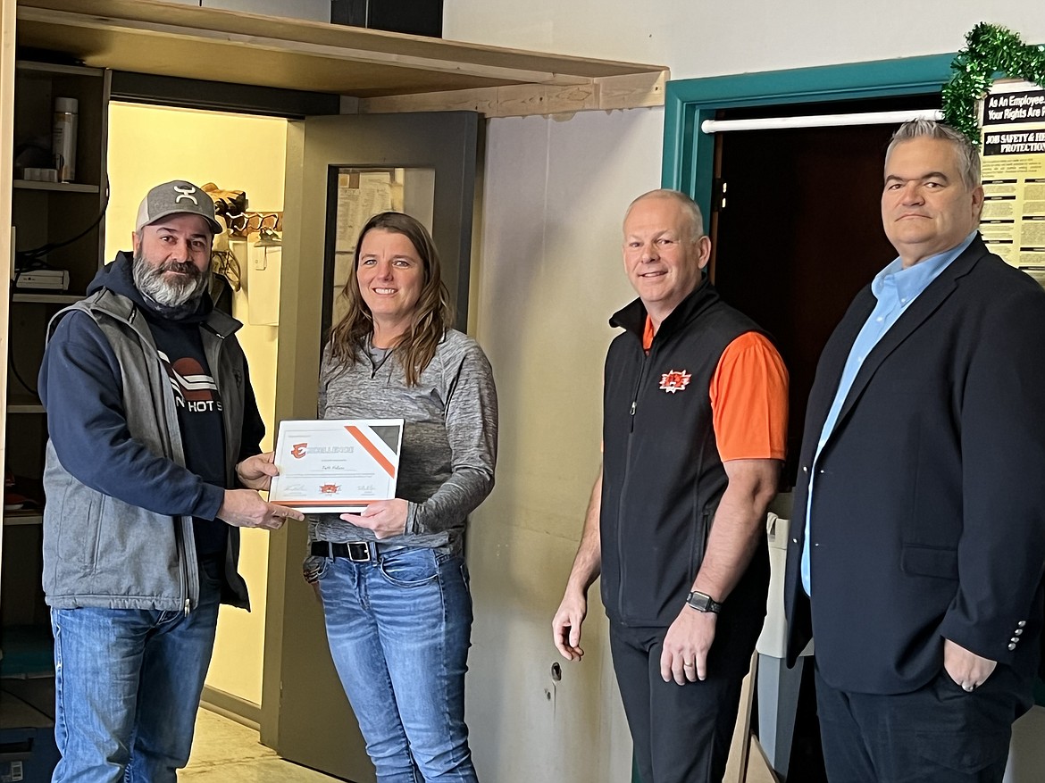 Ephrata School District bus driver Patti Helaas (second from left) receives the district’s Excellence Award from district transportation director Adam Roduner, district superintendent Tim Payne (second from right) and Jim Adams (right) vice-chair of the Ephrata School Board. Helaas recently saved a child who was choking.