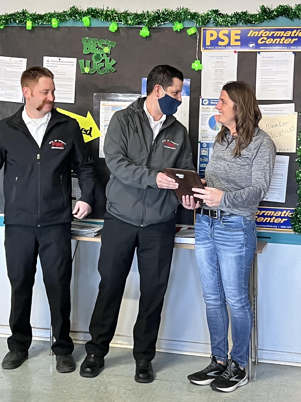 Ephrata Fire Department chief Jeremy Burns (center) awards Ephrata School District bus driver Patti Helaas (right) with the EFD Civilian Life Saving Award after she saved a child who was choking. Also pictured is EFD deputy chief Anthony Graaff (left).