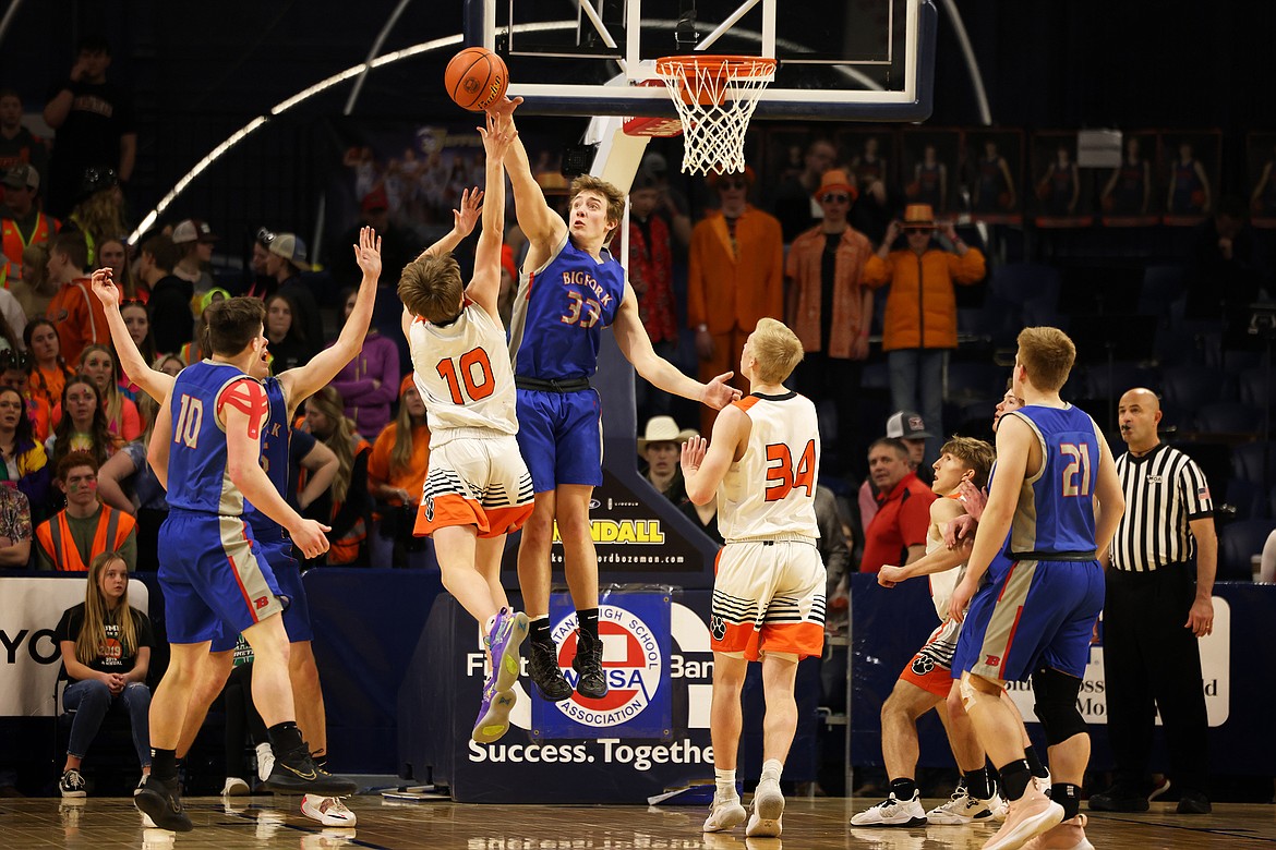 Bigfork's Nick Walker sends back a shot by Manhattan's Callin Fenno in the fourth quarter of the Vikings 55-46 win in the opening round of the State B Basketball Tournament in Bozeman Thursday. (Jeremy Weber/Bigfork Eagle)