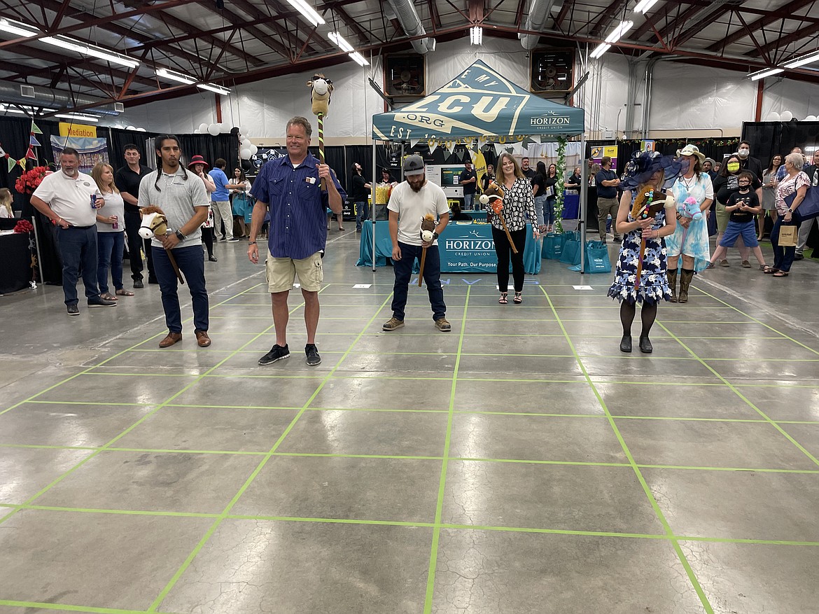 “Horse racers” Esteban Miron, Rich Victor, Daniel Mende, Danielle Boss, Vicki Rivers and Shannon “Shanbo” Waters near the end of their race held as part of the 2021 Kentucky Derby-themed Moses Lake Business Expo, held last year at the Grant County Fairgrounds in June. The theme for this year’s Business Expo is the Irish-themed “Find Your Pot of Gold” to mark St. Patrick’s Day, March 15, when this year’s expo is scheduled to be held.