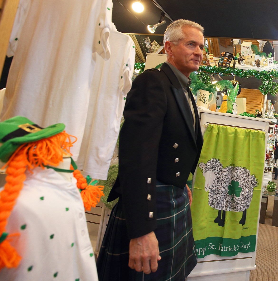 Kootenai County Prosecutor Barry McHugh emerges from the dressing room at All Things Irish on Saturday after putting on the outfit he'll be wearing as grand marshal for the 17th annual St. Patrick's Day Parade in downtown Coeur d'Alene on Saturday.