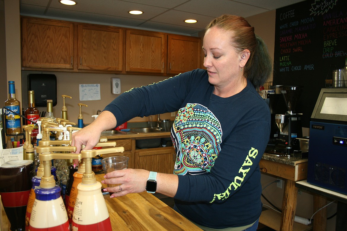 Sky’s Coffee owner Alisha Avalos adds flavoring to a coffee order. The shop offers coffee, hot chocolate, smoothies and other beverages made-to-order.