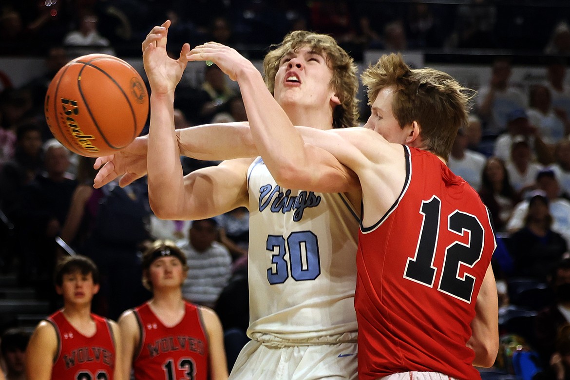 Bigfork's Eli Thorness is hacked by Three Forks defender Owen Long during action in the State B basketball semifinals in Bozeman on Friday, March 11. (Jeremy Weber/Daily Inter Lake)