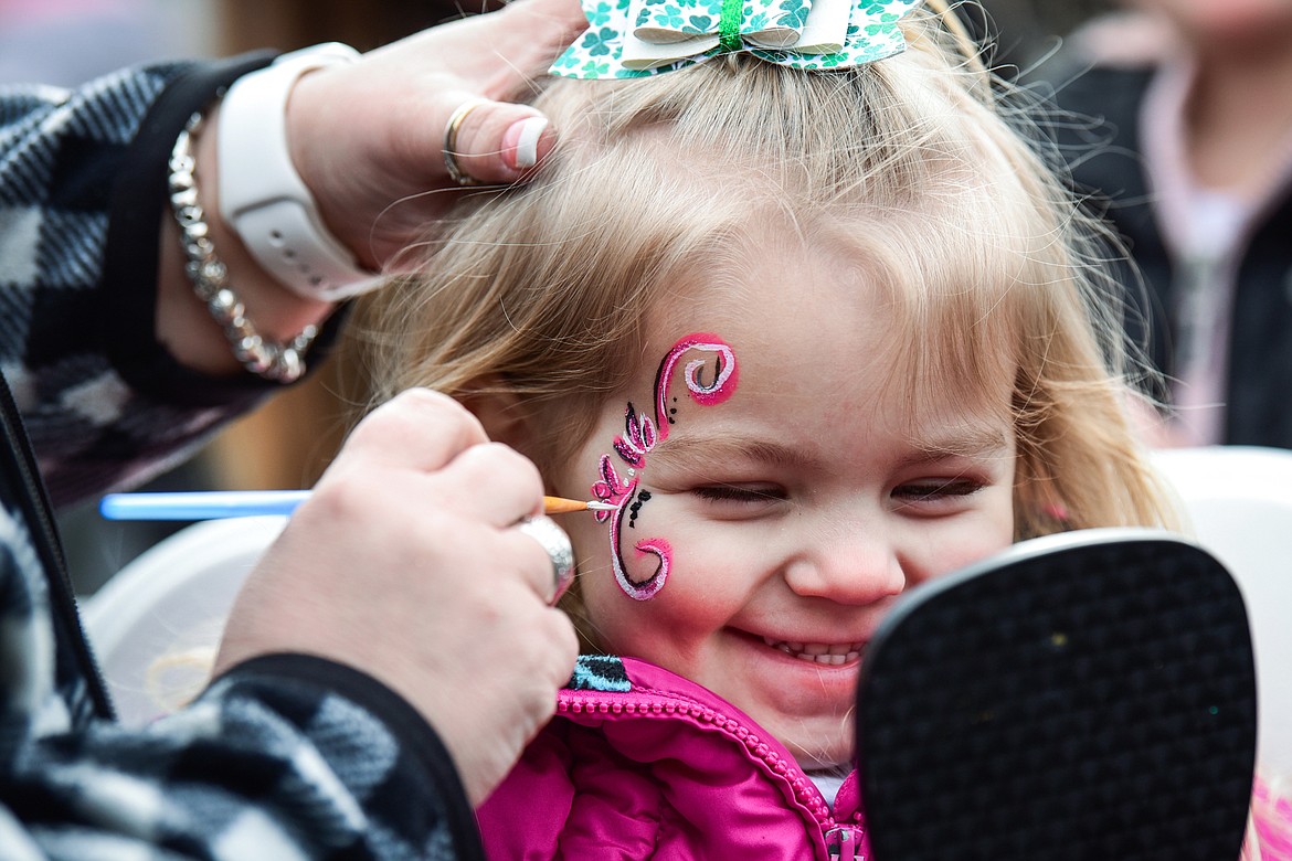 Piper Becker smiles as she gets her face painted by Andrea Robinson at Cloverfest at the Super 1 Foods in Columbia Falls on Saturday, March 12.  (Casey Kreider/Daily Inter Lake)