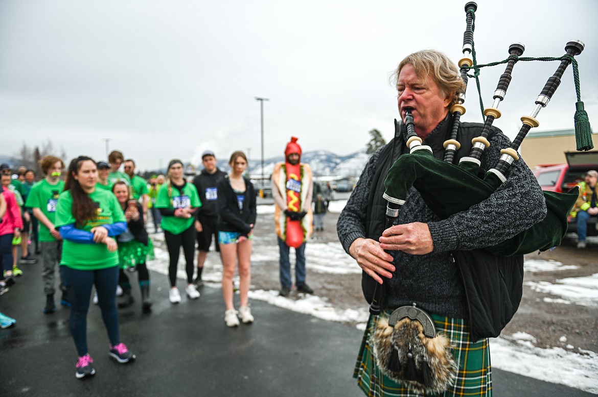 Montana Bagpiper Michael Gilbert plays the national anthem of Ireland before the start of the 5K race at Cloverfest at the Super 1 Foods in Columbia Falls on Saturday, March 12. The event also included a kids' carnival, fun run, live music, food trucks, local spirits and St Patrick’s Day activities and games. (Casey Kreider/Daily Inter Lake)