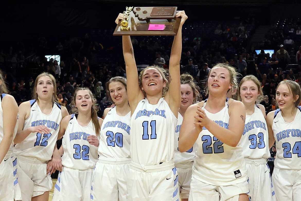 The Valkyries celebrate after downing Glasgow 59-49 to take third at the State B Basketball Tournament in Bozeman Saturday. (Jeremy Weber/Bigfork Eagle)