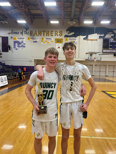 Aidan Heikes, left, and TreyVaughn Bierlink, right, pose after winning the district title at Wenatchee High School on Feb. 11.