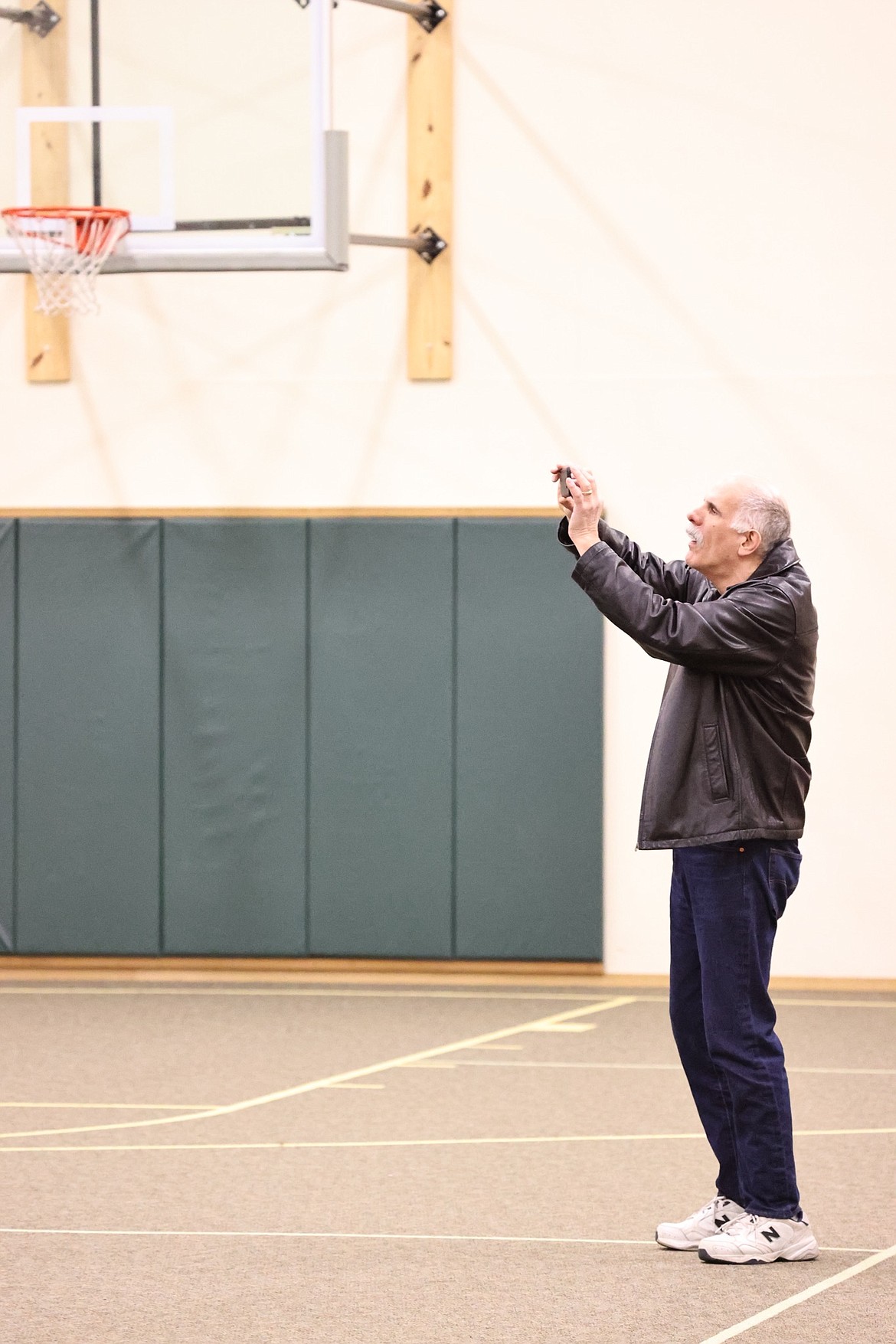 Brent Regan, Chairman of the KCRCC takes a cellphone photograph of legislators at a recent Legislative Town Hall sponsored by the Kootenai County Republican Central Committee.