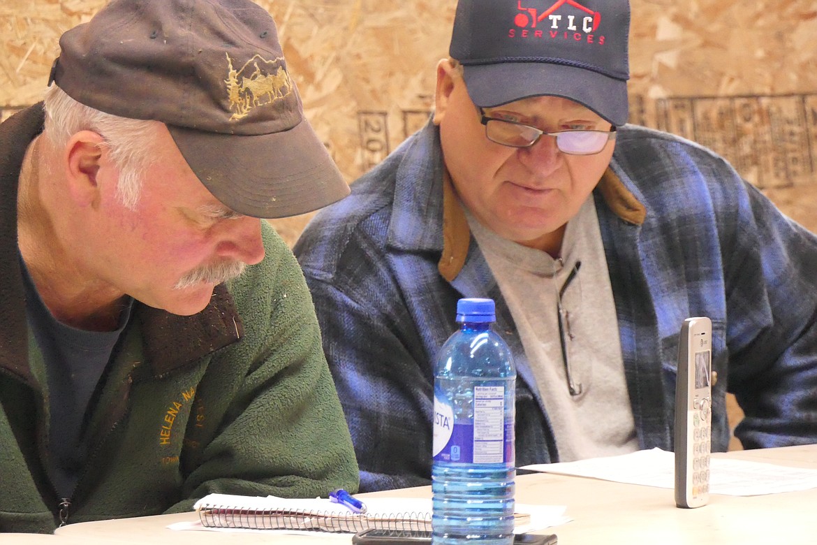 Paradise Sewer Board members Dewey Arnold and Terry Caldwell look over a new proposal from the land owner involving the controversial Paradise Sewer Project during a meeting last week.  (Chuck Bandel/VP-MI)